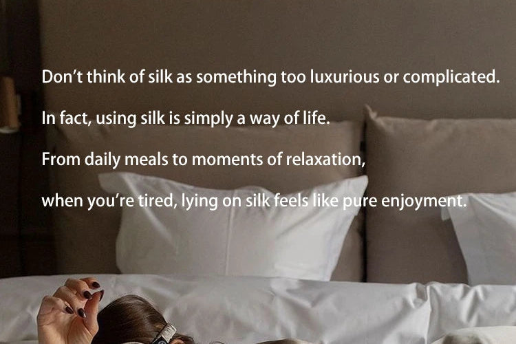 Person lying on a bed with white pillows and a quote about using silk as a way of life.
