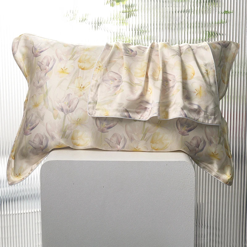Silk pillowcase with tulip floral pattern on a white surface