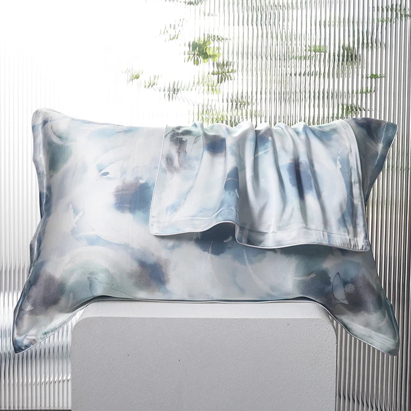 Decorative pillow with a tie-dye pattern on a white surface.